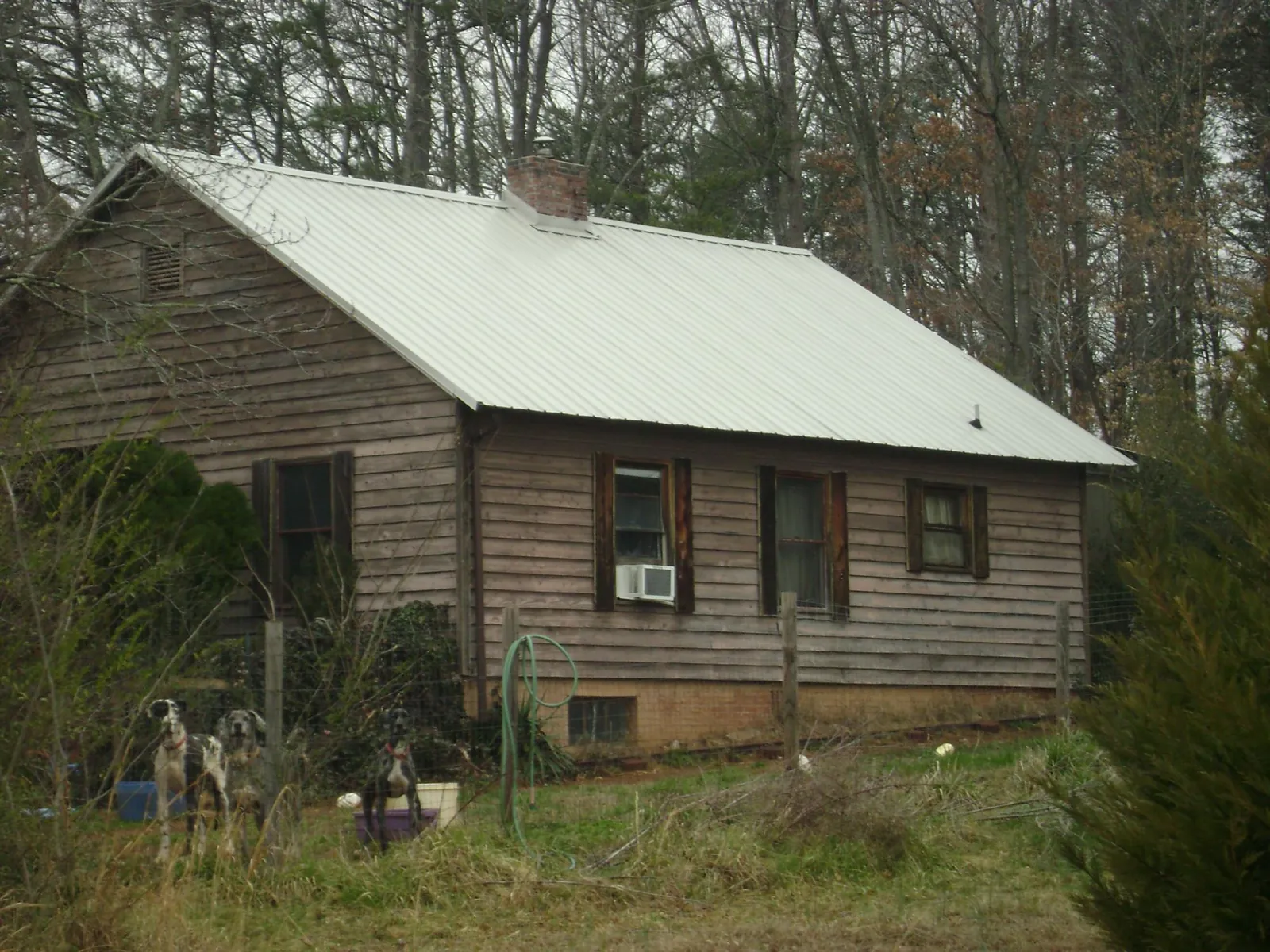 White metal roof on an old wood sided farmhouse, from a Metal Roof Installation job in Elk Park